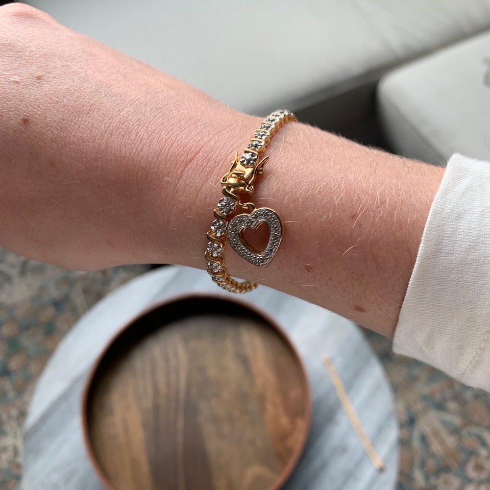 Gold tennis bracelet with heart clasp